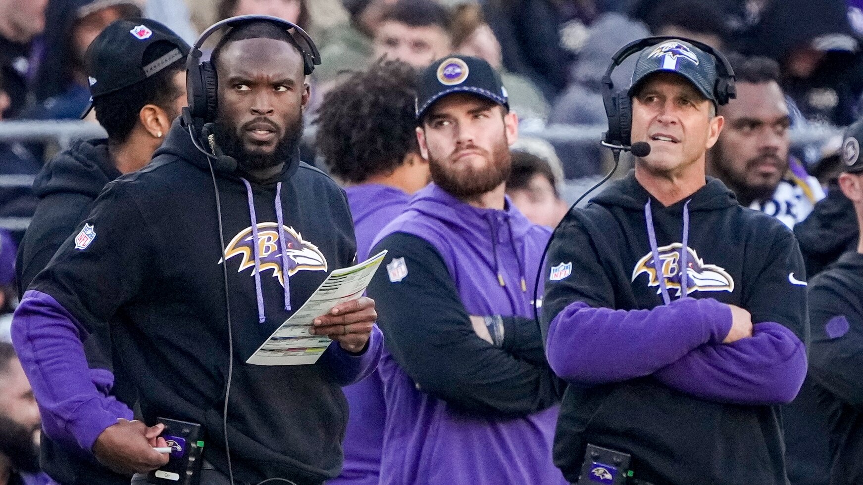 Baltimore Ravens defensive coordinator Zach Orr, left, and head coach John Harbaugh call plays from the sidelines in a regular season game against the Denver Broncos at M&T Bank Stadium on Sunday, November 3, 2024.