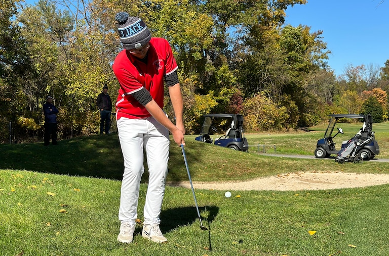Centennial's Dustin Stocksdale chips onto the green on the par 5 fifth hole at Fairway Hills Thursday. He made clutch shots all day to win the Howard County boys high school championship. It was his first high school tournament victory ever.