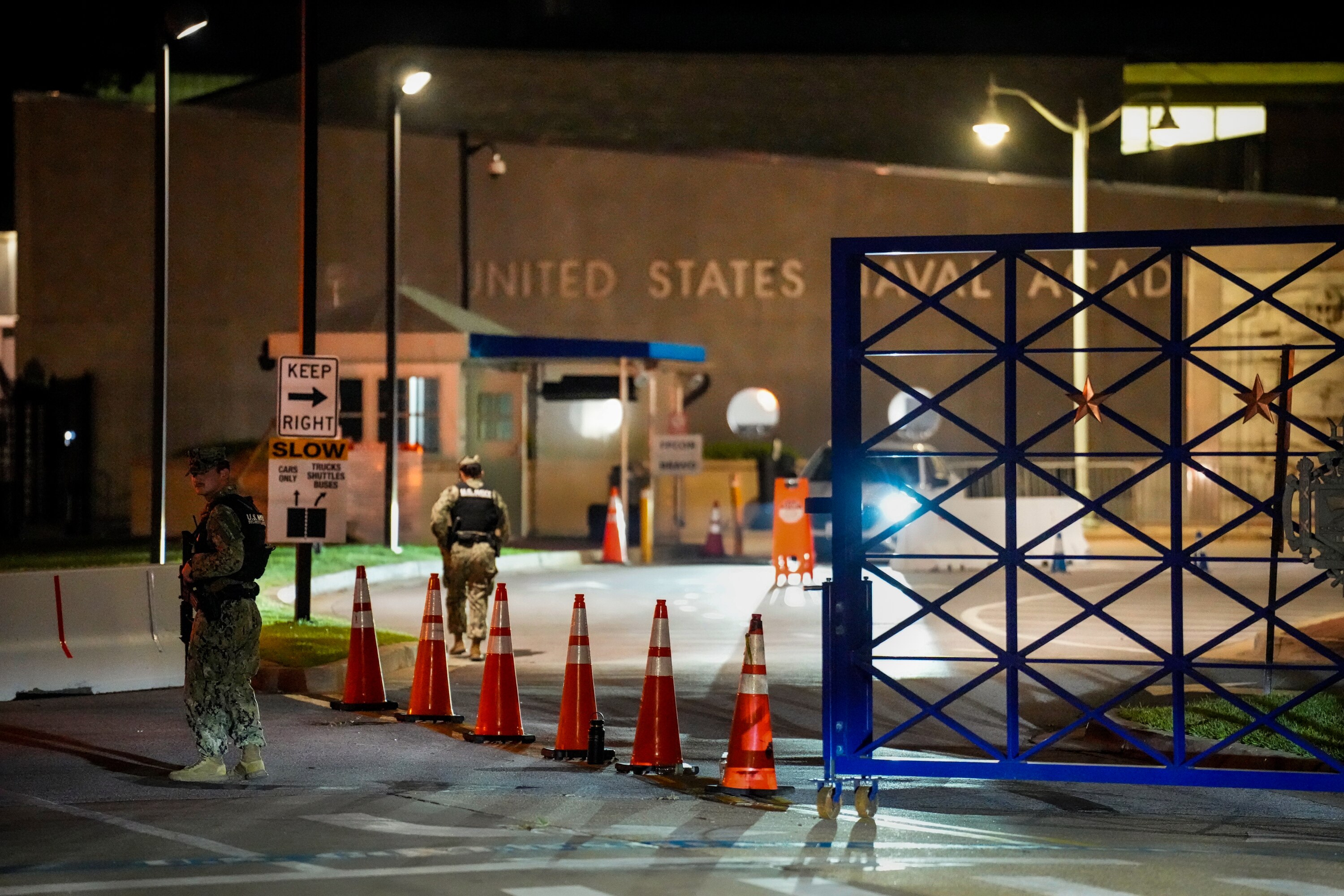 Navy security officers guard the main entrance of the Naval Academy on Thursday evening after the campus was put on lockdown.