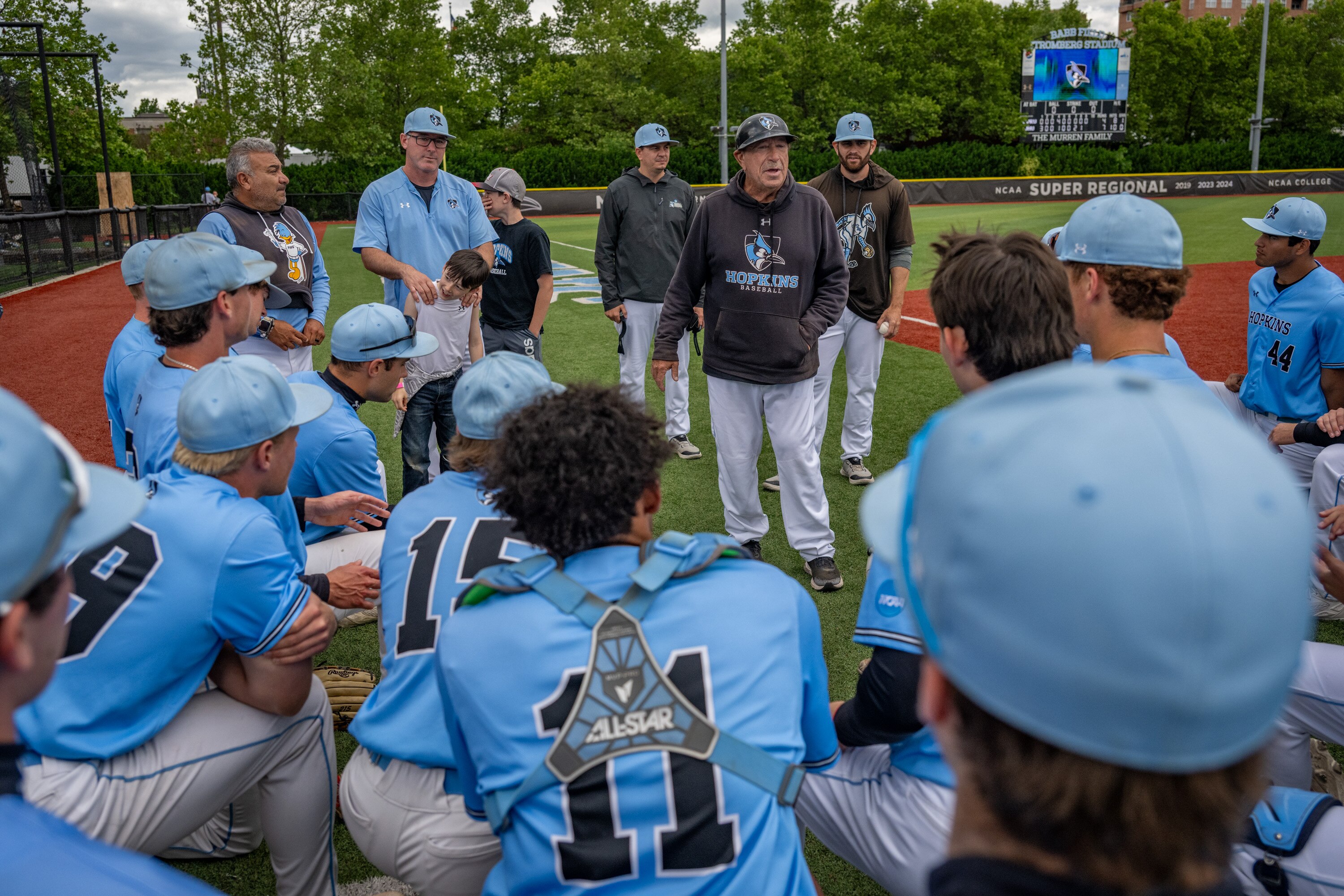 Johns Hopkins head baseball coach Bob Babb congratulates his team on a hard-fought win against Case Western Reserve University on Friday.