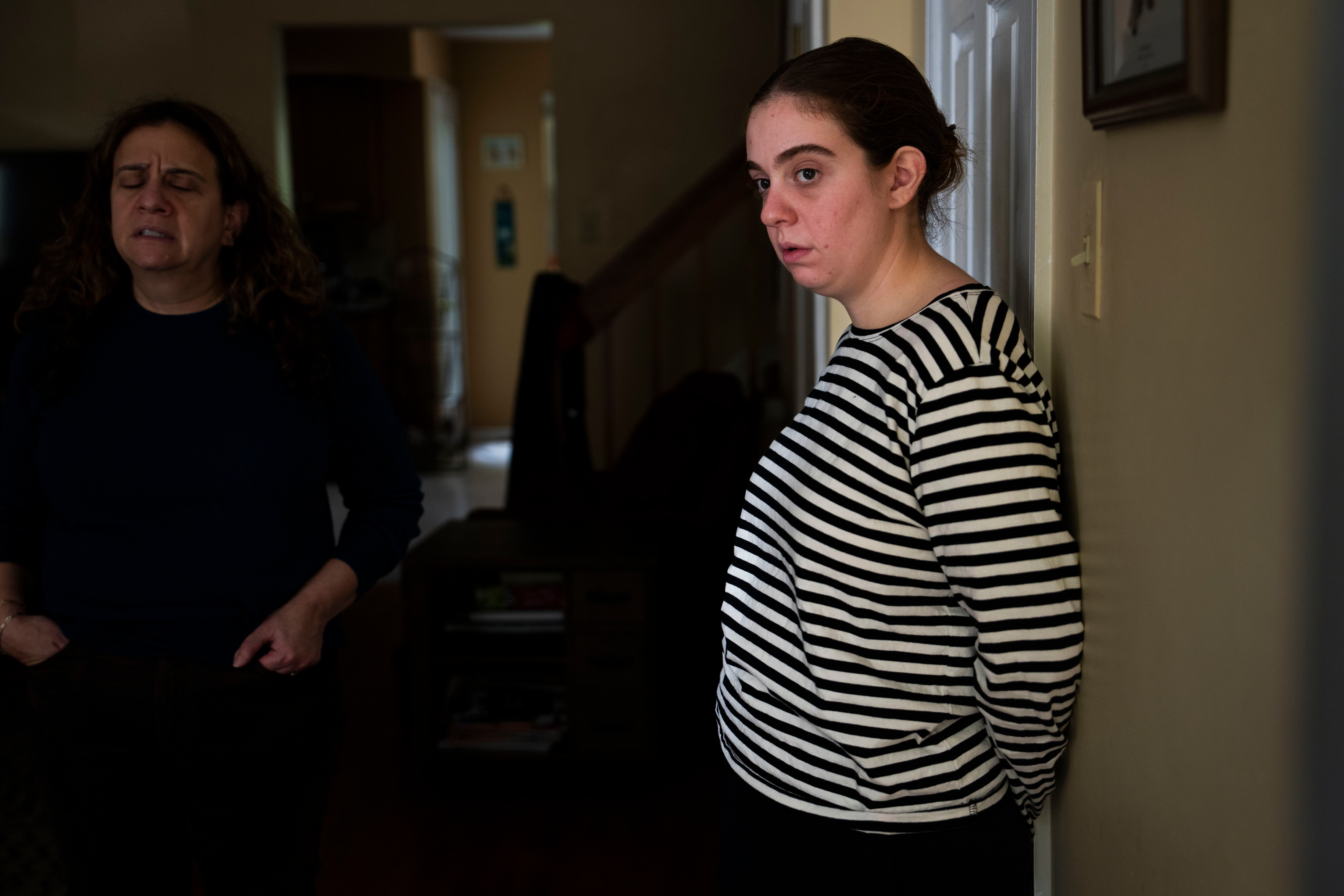 Gabi discusses her impending military service with her mom, Jamie, in their home on Oct. 19, 2023. Jamie has a folder of baby photos of Gabi to share.