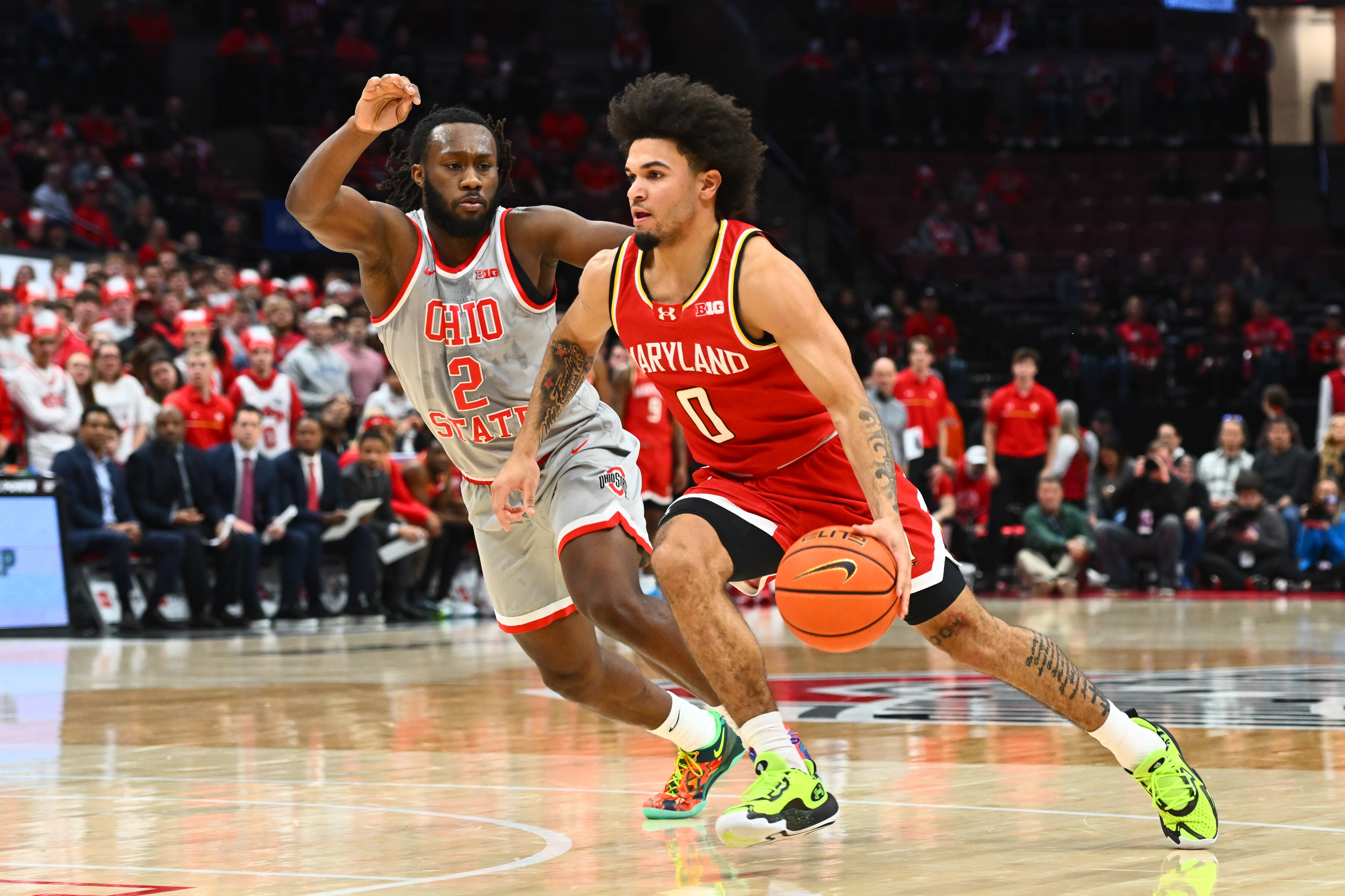 Ja’Kobi Gillespie of Maryland advances the ball as Bruce Thornton of Ohio State defends.