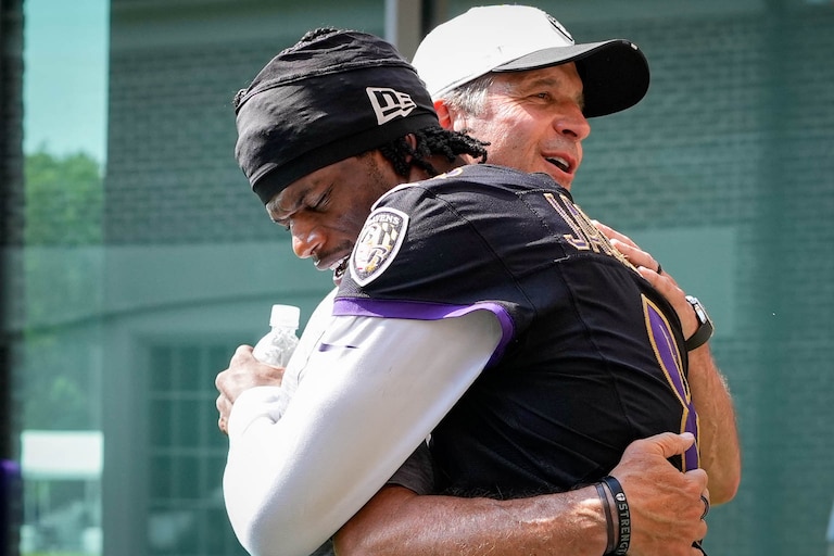 Baltimore Ravens head coach John Harbaugh embraces quarterback Lamar Jackson (8) following the team’s training camp session at the Under Armour Performance Center in Owings Mills, Md. on Wednesday, July 13, 2025.