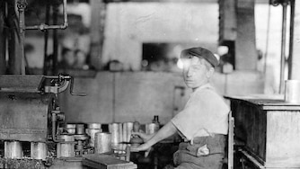Lewis Wickes Hine, Dangerous Business. Boy working at canning machine with open gearing. Many such machines and boys too. J. S. Farrand Packing Co., Baltimore, Maryland, 1909. Gelatin silver print, 5 x 7 in. The Photography Collections, University of Maryland, Baltimore County (UMBC), P858