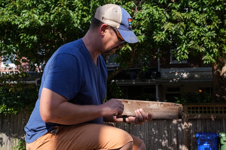 Archaeologist Dave Gadsby examines a piece of Mathilda Lorenz’s empty casket on July 28, 2022. The mysterious casket was originally found down by a stream in Wyman Park.