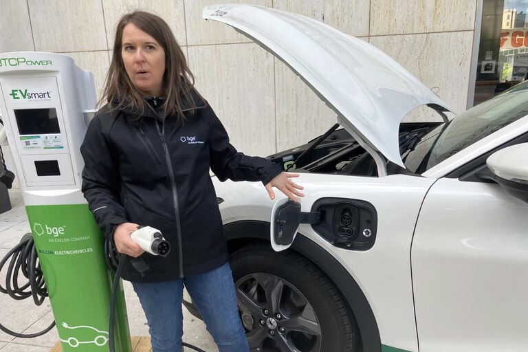 Stephanie Leach with BGE demonstrates EV charging at an event at State Center in Baltimore.