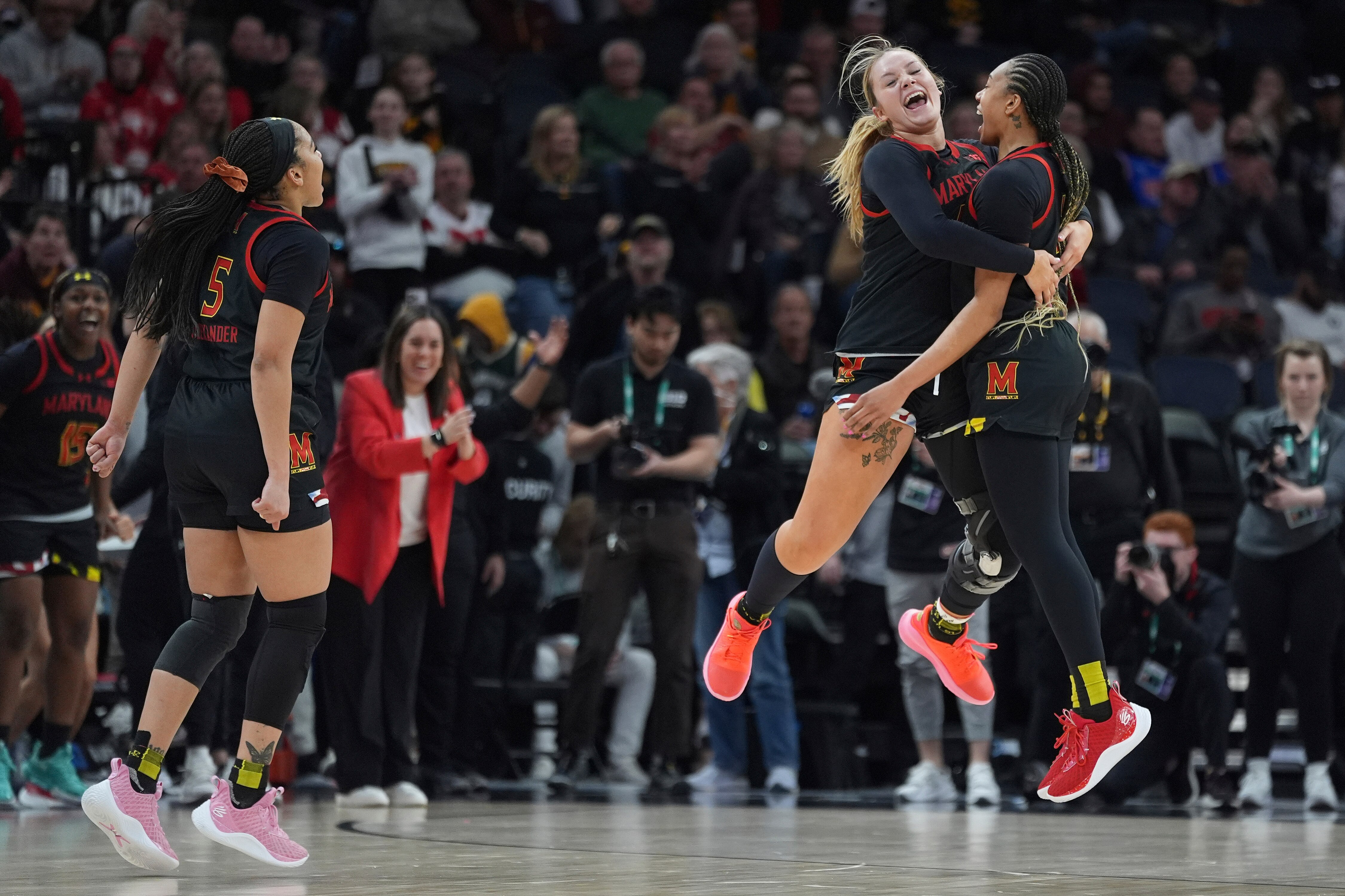 Maryland forward Allie Kubek, center, and guard Jakia Brown-Turner, right, celebrate Maryland's upset of Ohio State on Thursday in Minneapolis.