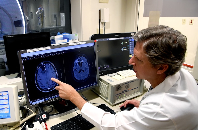 Dr. Graeme F. Woodworth, chief of neurosurgery at the University of Maryland Medical Center, monitors a patient’s brain during a study of a promising new way to treat glioblastomas.