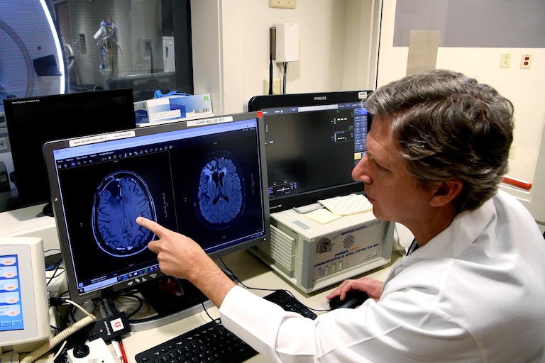 Dr. Graeme F. Woodworth, chief of neurosurgery at the University of Maryland Medical Center, monitors a patient’s brain during a study of a promising new way to treat glioblastomas.