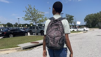 Ethan walks out of Paint Branch High School during his second week at the comprehensive campus, which is 28 times the size of his last school.