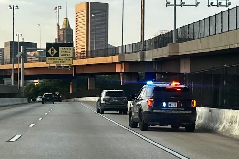 A Baltimore Police officer pulls over a vehicle driving on 395-N heading downtown on Thursday, July 18, 2024.