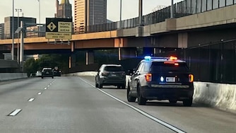 A Baltimore Police officer pulls over a vehicle driving on 395-N heading downtown on Thursday, July 18, 2024.
