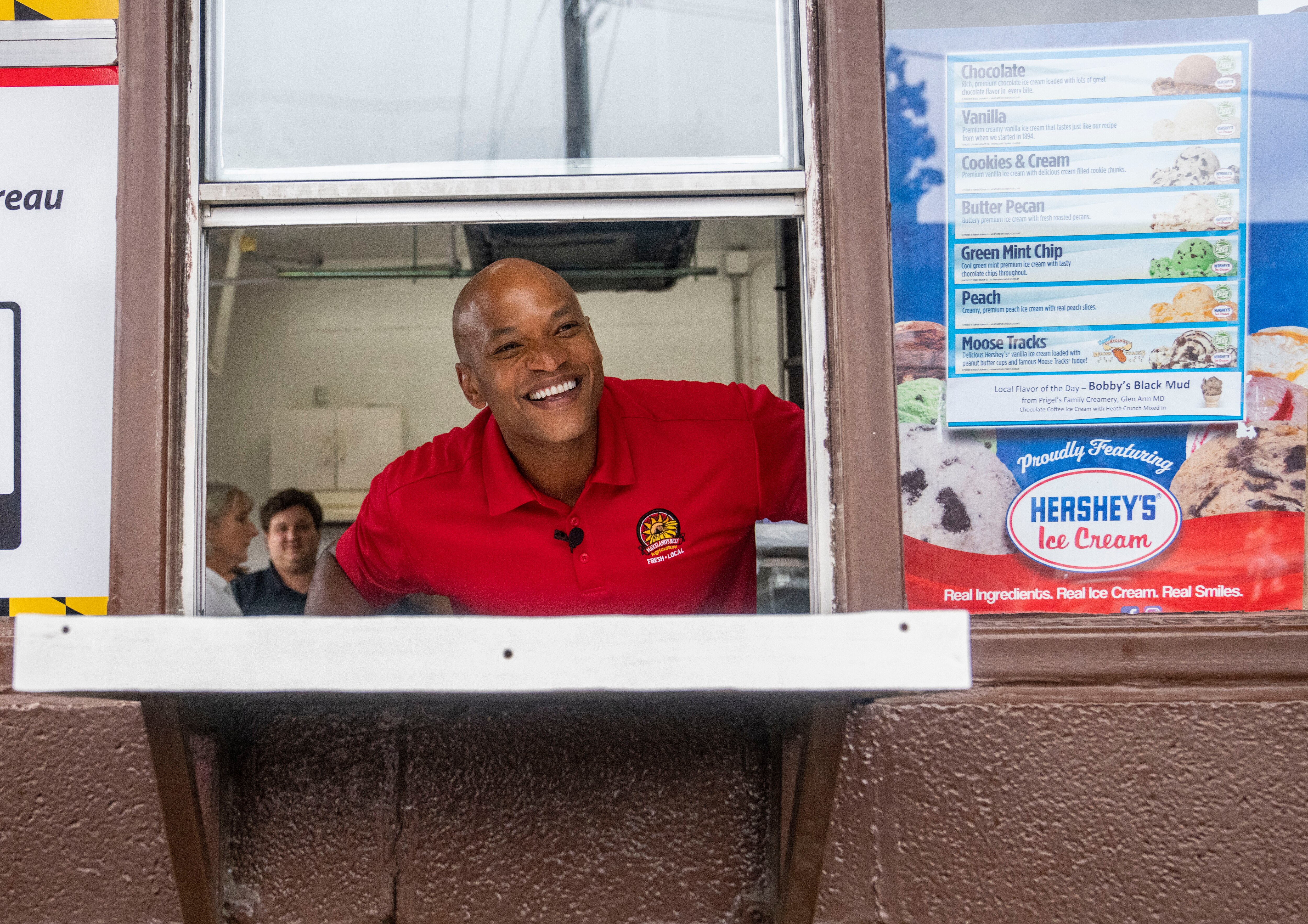 Not quite as popular as ice cream, but Maryland Gov. Wes Moore had strong favorability ratings in a new poll. He is pictured here Aug. 30, 2024, taking ice cream orders at the Maryland State Fair in Timonium.
