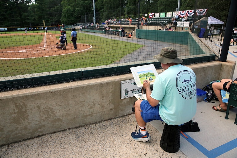 Potomac resident Mark Adler uses watercolors to paint a scene of a Bethesda Big Train game during their live plein air painting night that features around a dozen artists. This season's third annual showcase takes place June 27.