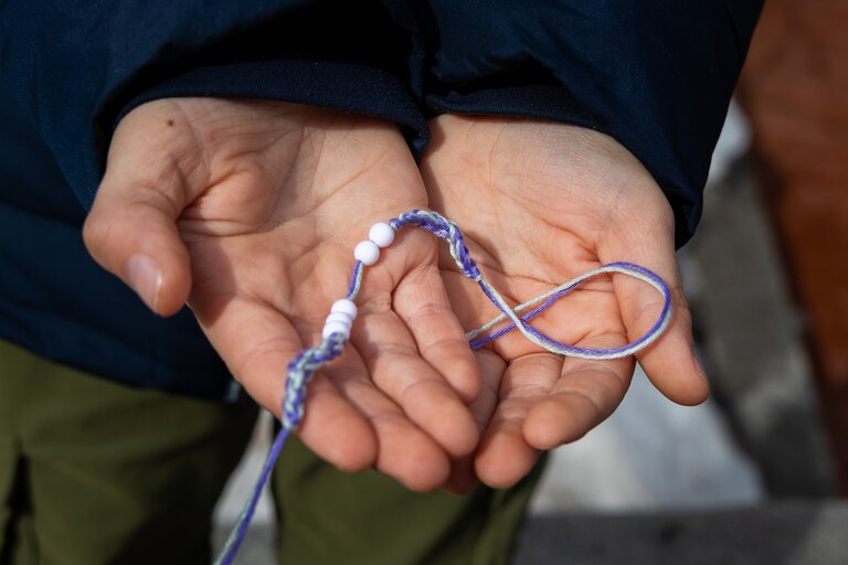 THURSDAY, FEBRUARY 12, 2026 - Griffin Callaghan, 7, recieves one of the many bracelet given out from the Theravada Buddhist Monks in Annapolis, MD.