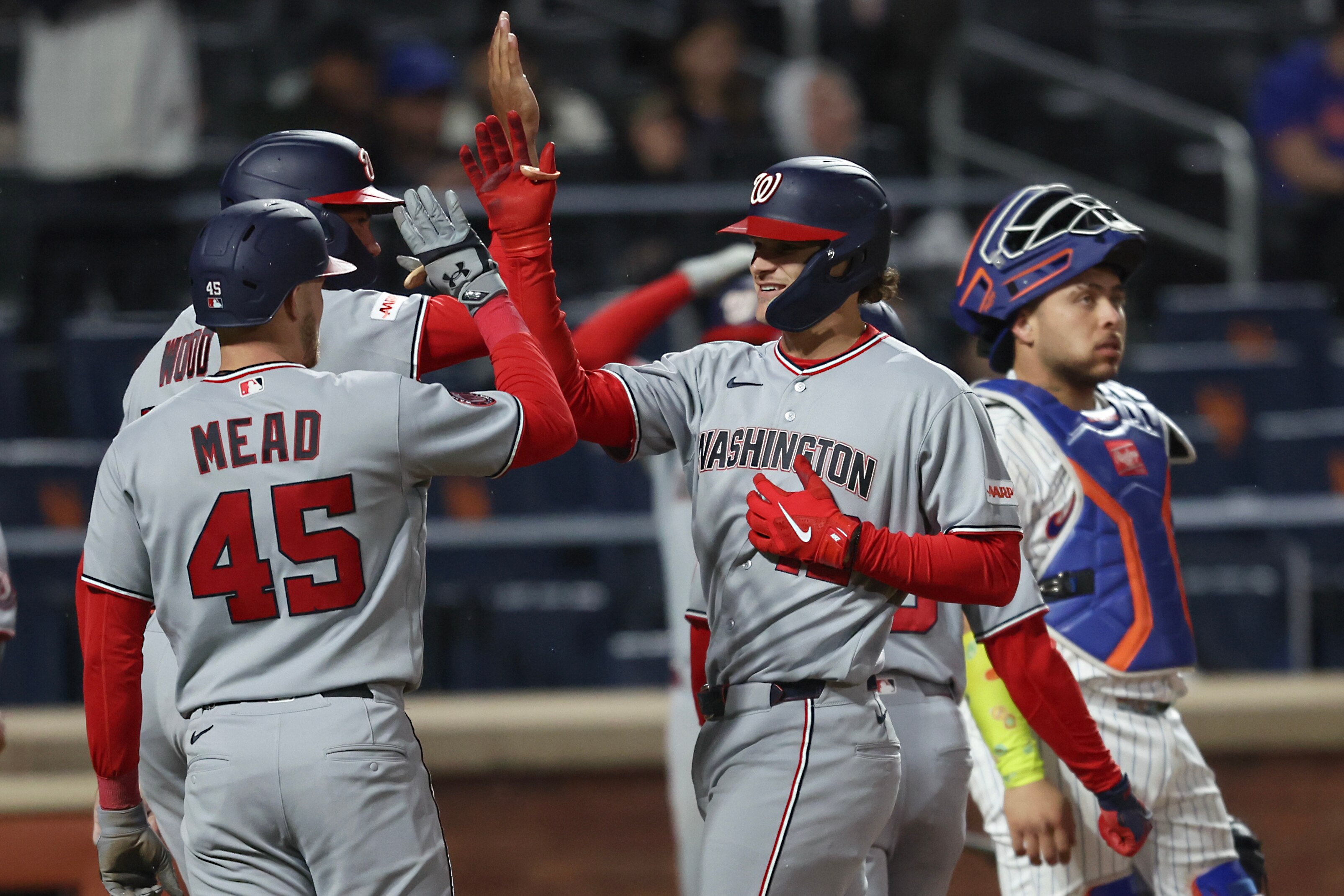 Brady House of the Nationals, center, receives greetings from teammates after his grand slam in the fourth inning Wednesday night.
