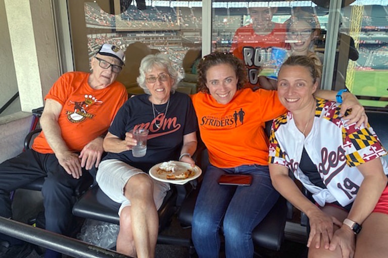 Larry Aaronson and his wife Connie with their daughters Debbie and Abby at an Orioles game in 2019.