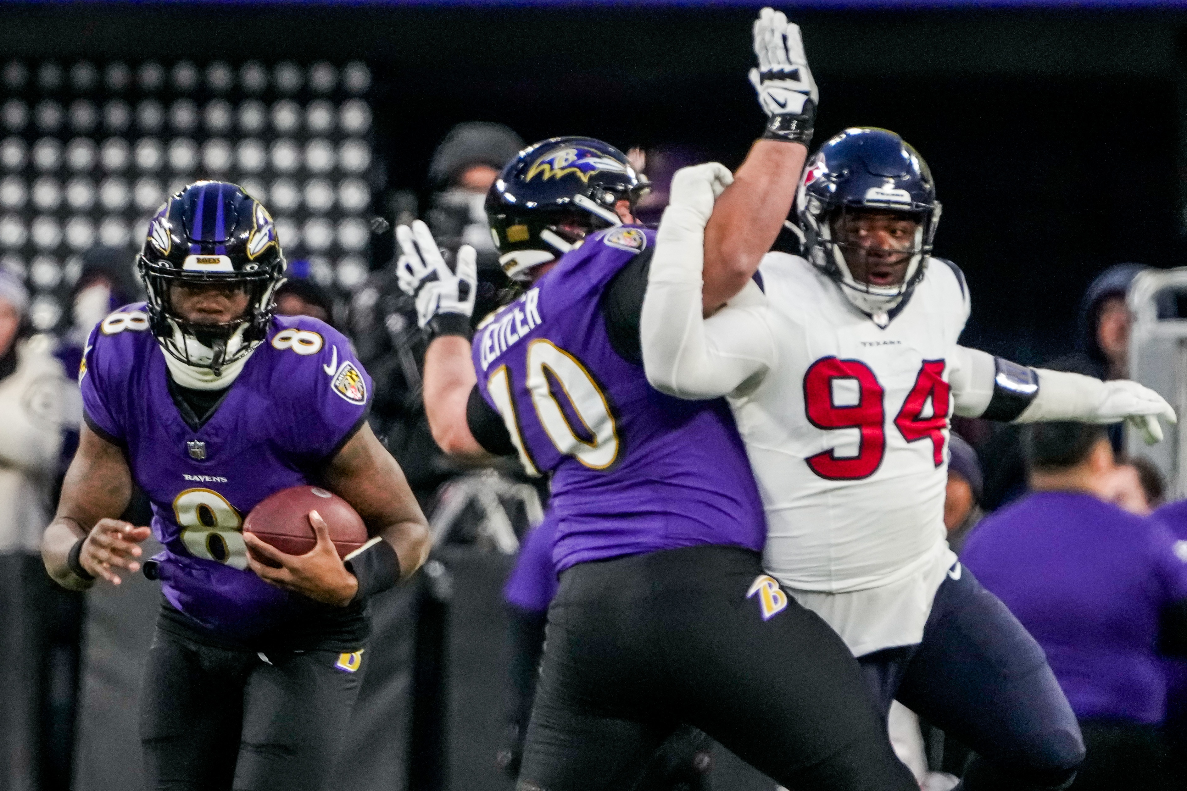 Ravens guard Kevin Zeitler blocks Houston Texans defensive tackle Khalil Davis, clearing a patch for quarterback Lamar Jackson.