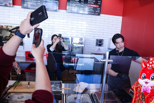 Kimberly Kong and videographer Minje Sun film an Instagram video of Kevin Hsieh preparing food at Bao Bei, a Taiwanese street food eatery in Rockville, Md. The restaurant is the 43rd stop in Kong’s series highlighting 100 Asian eateries on her social media platforms.