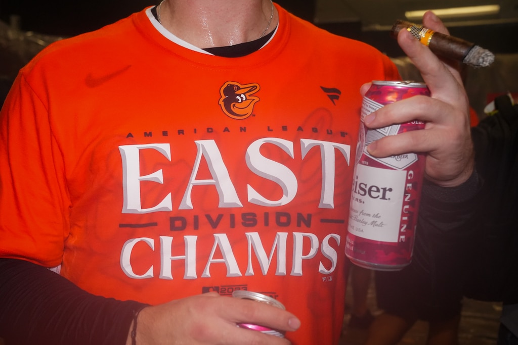 Baltimore Orioles catcher Adley Rutschman holds a cigar and two beers in the locker room after clinching the AL East division on Thursday, September 28, 2023. The beat the Boston Red Sox, 2-0, to secure control of the division.