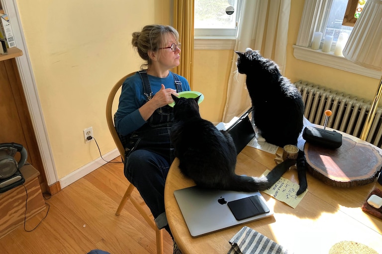 Christine Koniezhny at home in Baltimore in 2022 with cats Nicholas and Nico. Nico was a cat she rescued in New Orleans.