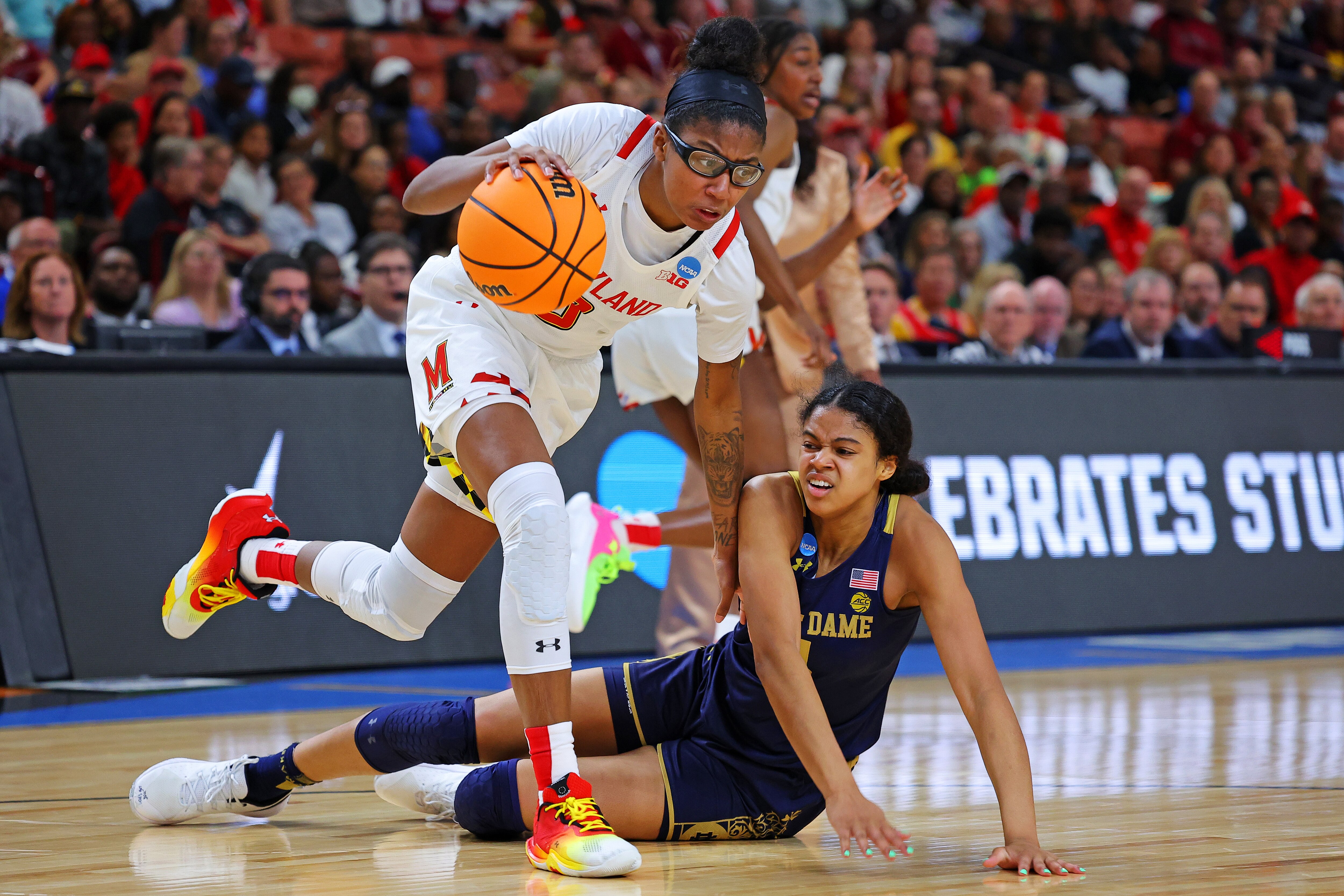 Shyanne Sellers #0 of the Maryland Terrapins and Cassandre Prosper #4 of the Notre Dame Fighting Irish go for a loose ball during the second half in the Sweet 16 round of the NCAA Women's Basketball Tournament at Bon Secours Wellness Arena on March 25, 2023 in Greenville, South Carolina.