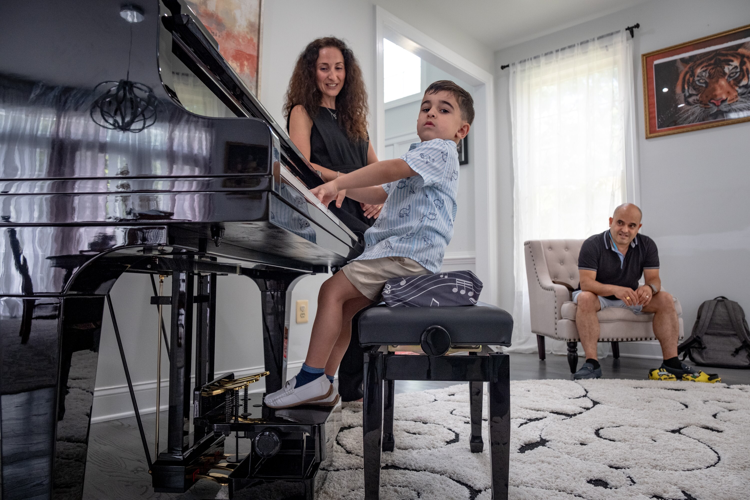 Piano teacher Elena Ayanyan, left, watches her student Michael Girgis, 4, close out a song while his father, Magdy Girgis, listens.