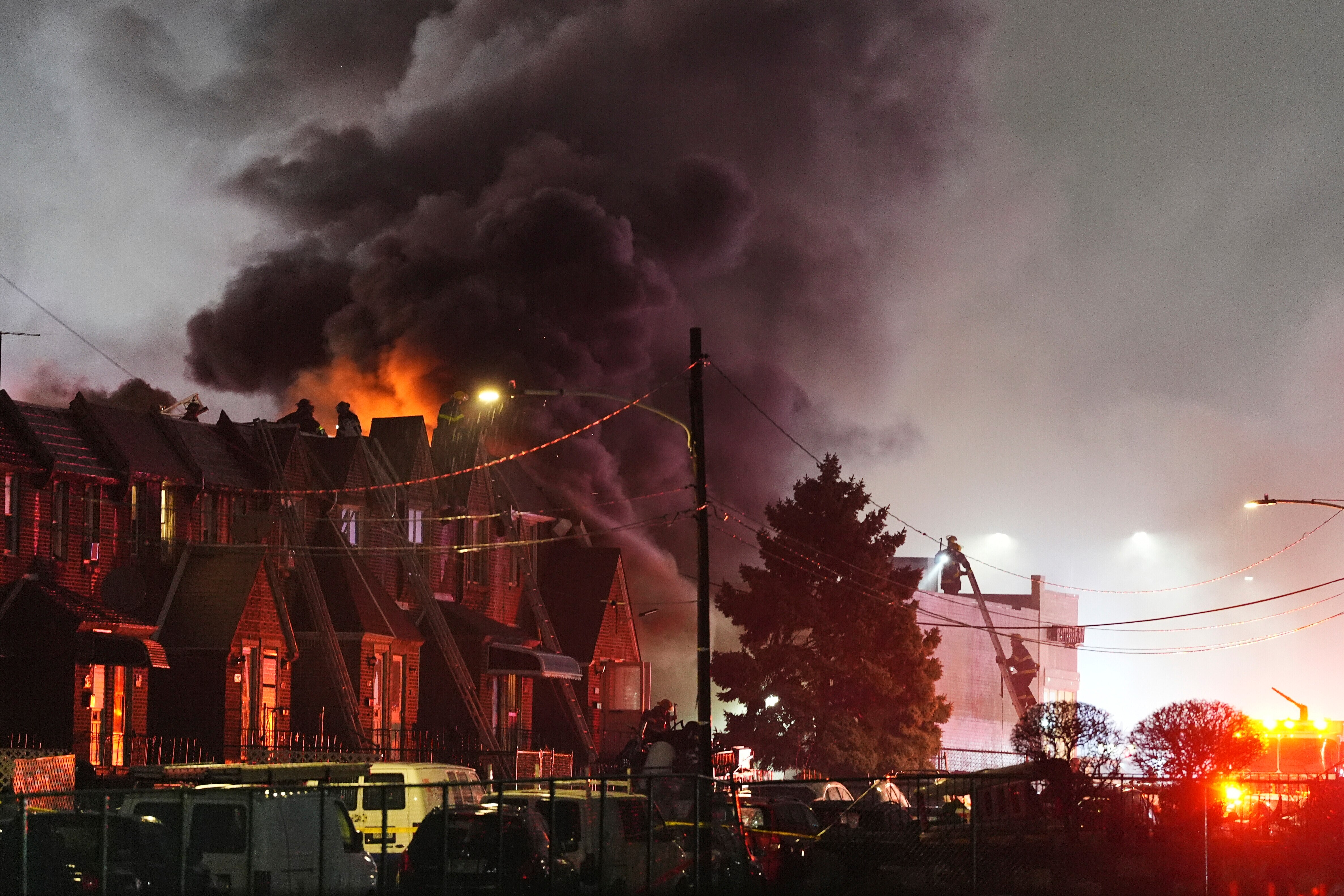 Smoke rises as first responders work the scene after a small plane crashed in Philadelphia, Friday, Jan. 31, 2025.