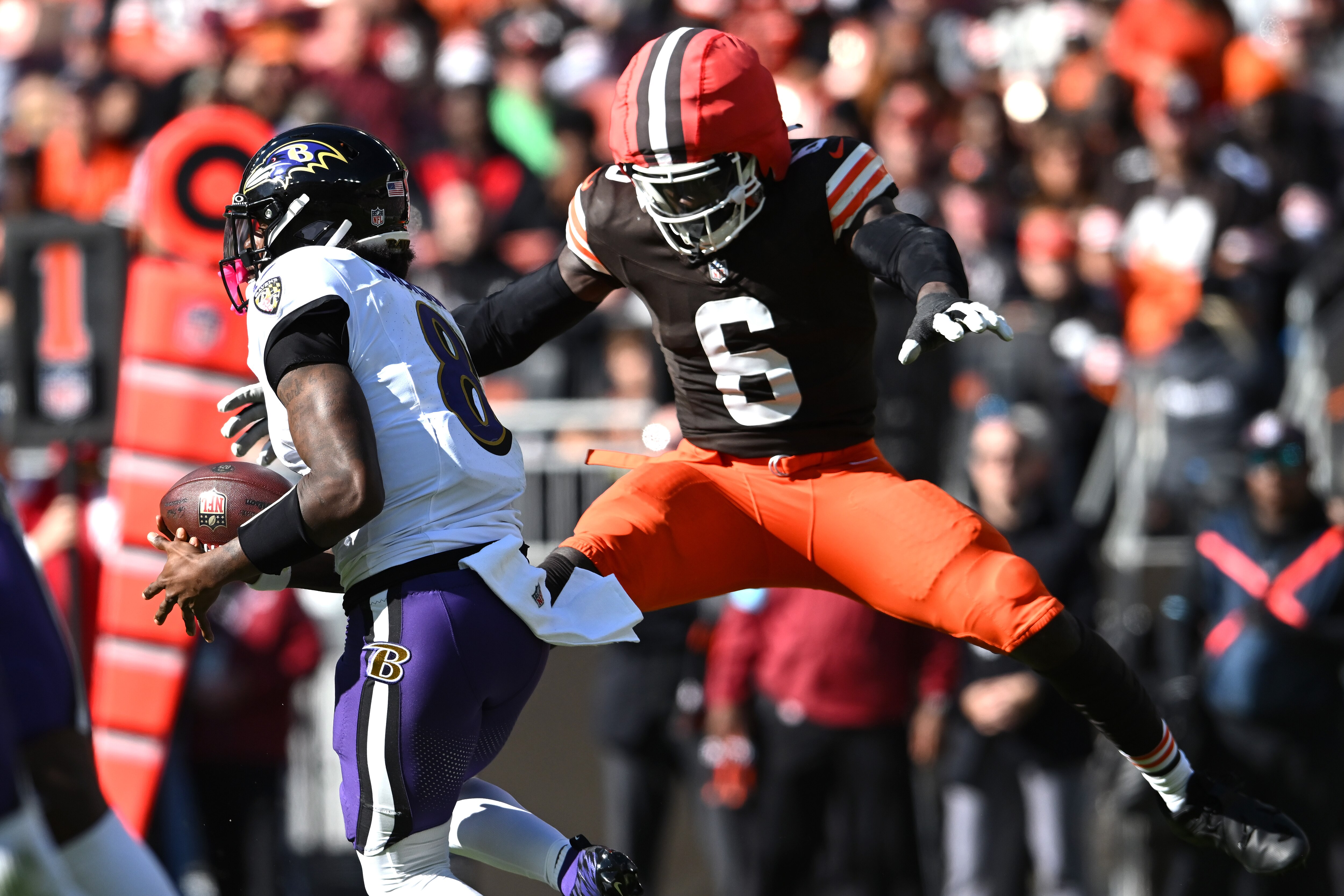 Ravens quarterback Lamar Jackson runs past Jeremiah Owusu-Koramoah of the Browns during the third quarter.