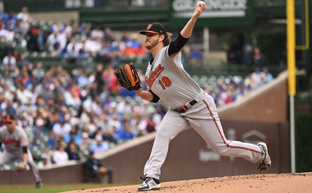 CHICAGO, IL - JUNE 16:  Cole Irvin #19 of the Baltimore Orioles pitches in the first inning against the Chicago Cubs at Wrigley Field on June 16, 2023 in Chicago, Illinois.