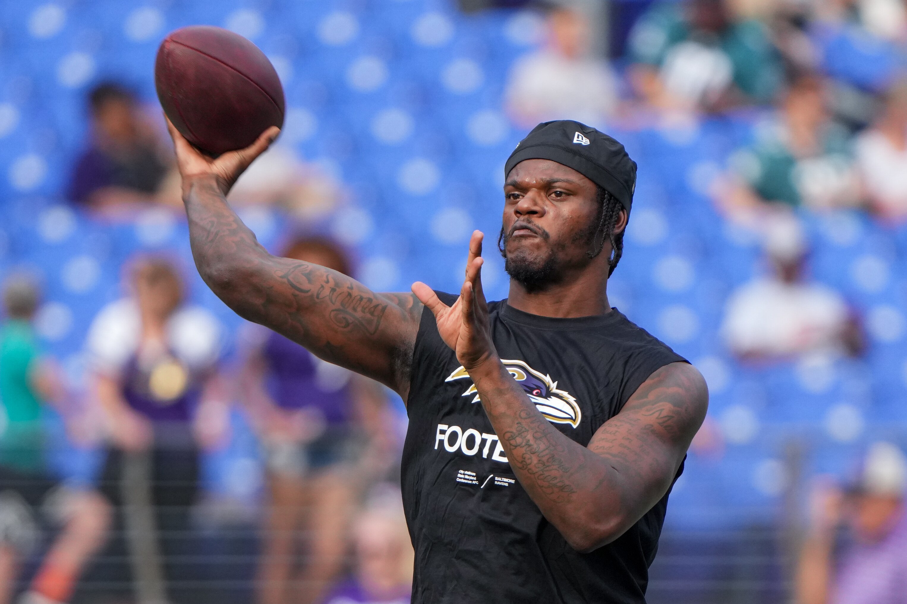 Baltimore Ravens quarterback Lamar Jackson (8) throws a pass during warmups of a preseason game against the Philadelphia Eagles at M&T Bank Stadium on Saturday, Aug. 12, 2023.