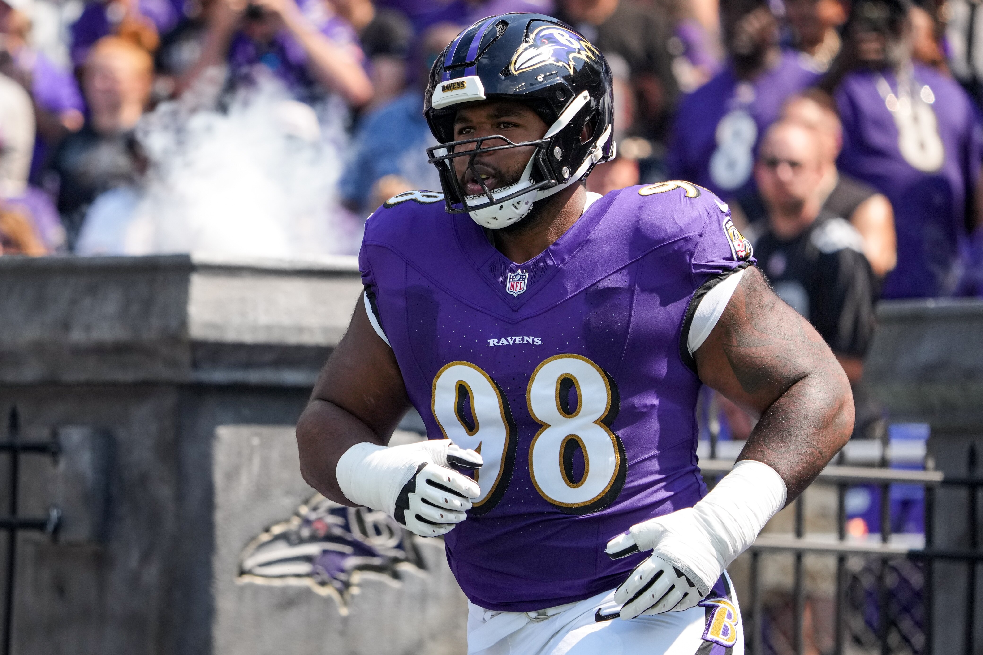 Baltimore Ravens defensive tackle Travis Jones (98) runs onto the field before his team’s home opening game against the Las Vegas Raiders at M&T Bank Stadium in Baltimore on Sunday, September 15, 2024.