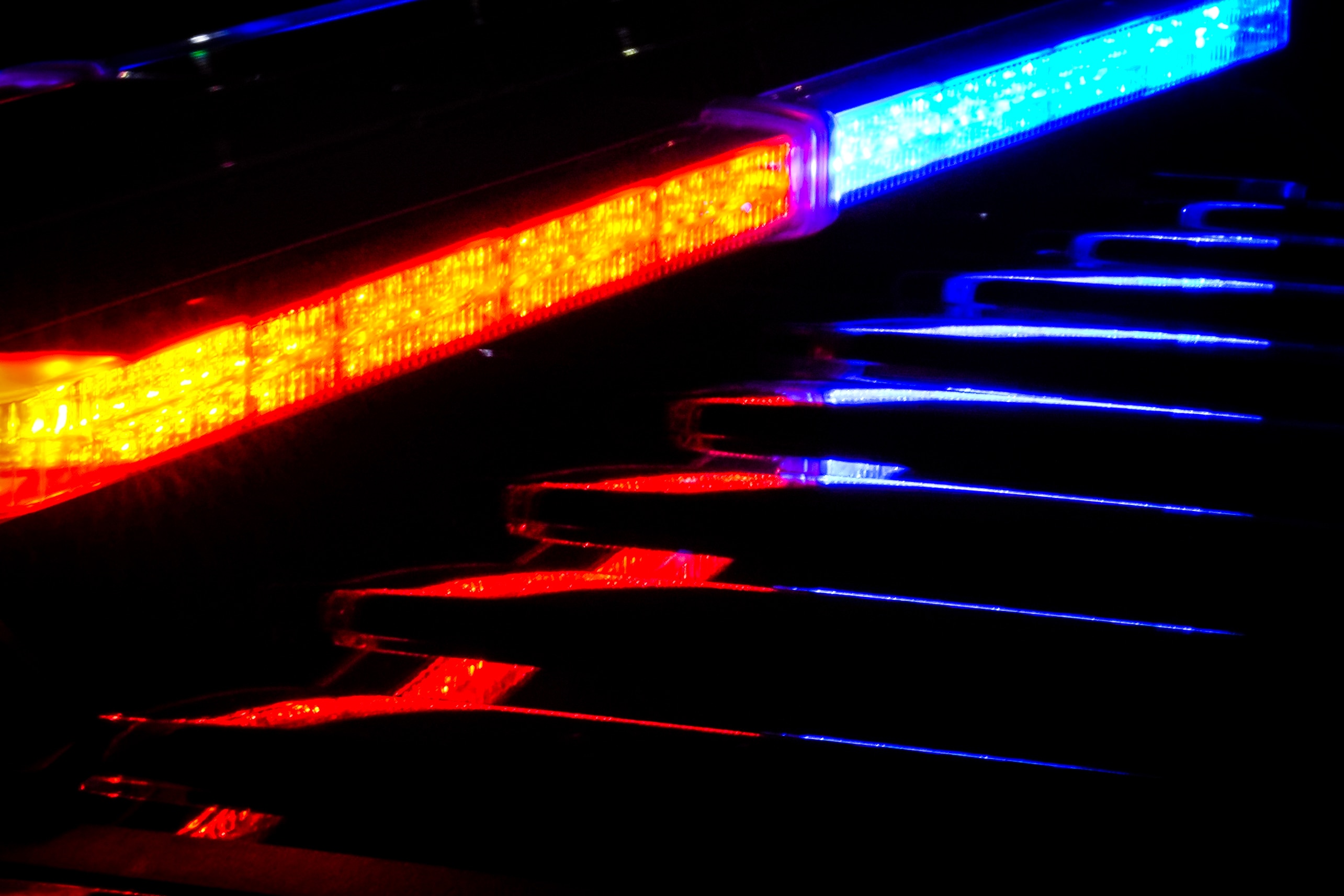 Baltimore Police lights flicker at night.