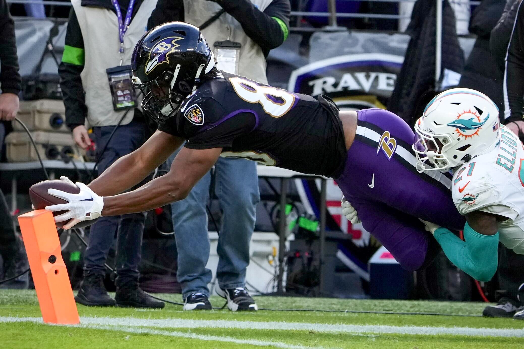 Ravens tight end Isaiah Likely dives to score one of his two touchdowns in Sunday's 56-19 win over the Miami Dolphins.