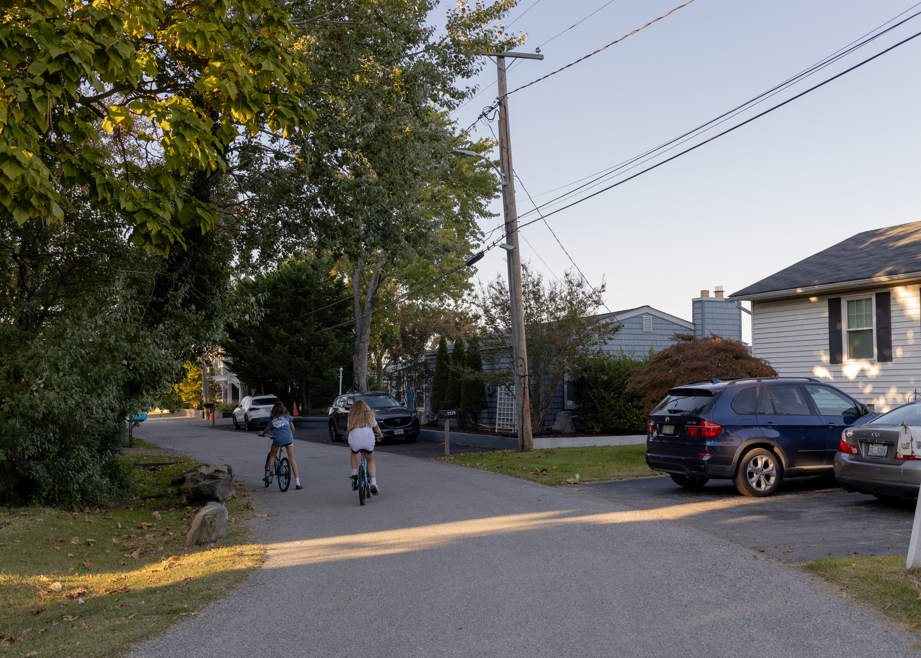 Kids ride bicycles through the Oyster Harbor private community in Annapolis, Md., on Oct. 11, 2024.