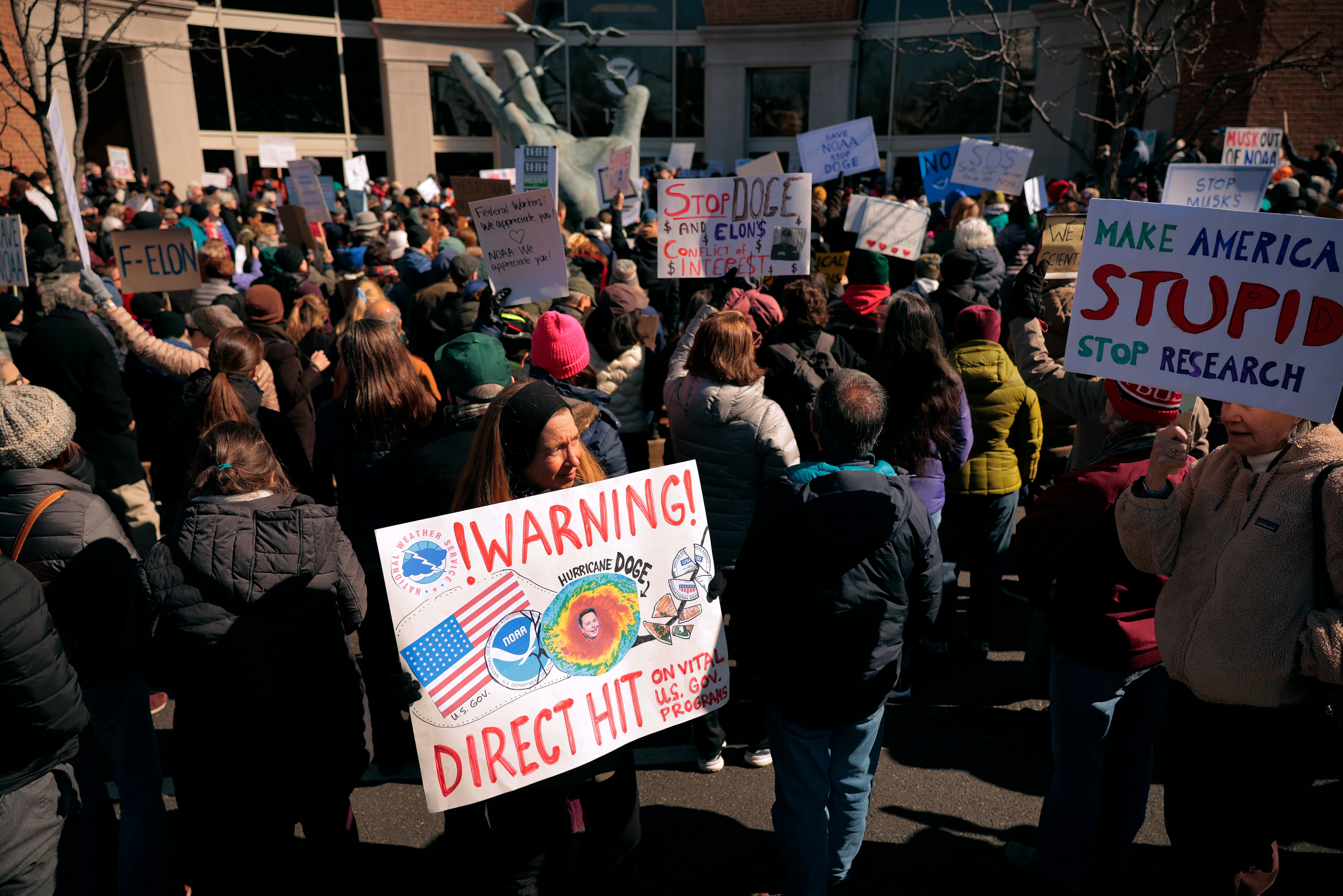 SILVER SPRING, MD - MARCH 03: Hundreds of demonstrators gather to protest against Department of Government Efficiency (DOGE) cuts outside the headquarters of the National Oceanic and Atmospheric Administration on March 03, 2025 in Silver Spring, Maryland. Last week the Trump administration fired about 800 probationary staff at NOAA, one of the world’s premier centers for climate science. The layoffs are on top of about 500 employees who left the agency after taking the so-called deferred resignation offer.