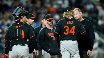 Orioles starter Shane Baz is checked on by manager Craig Albernaz and an athletic trainer before exiting the game with an injury in the fifth inning.