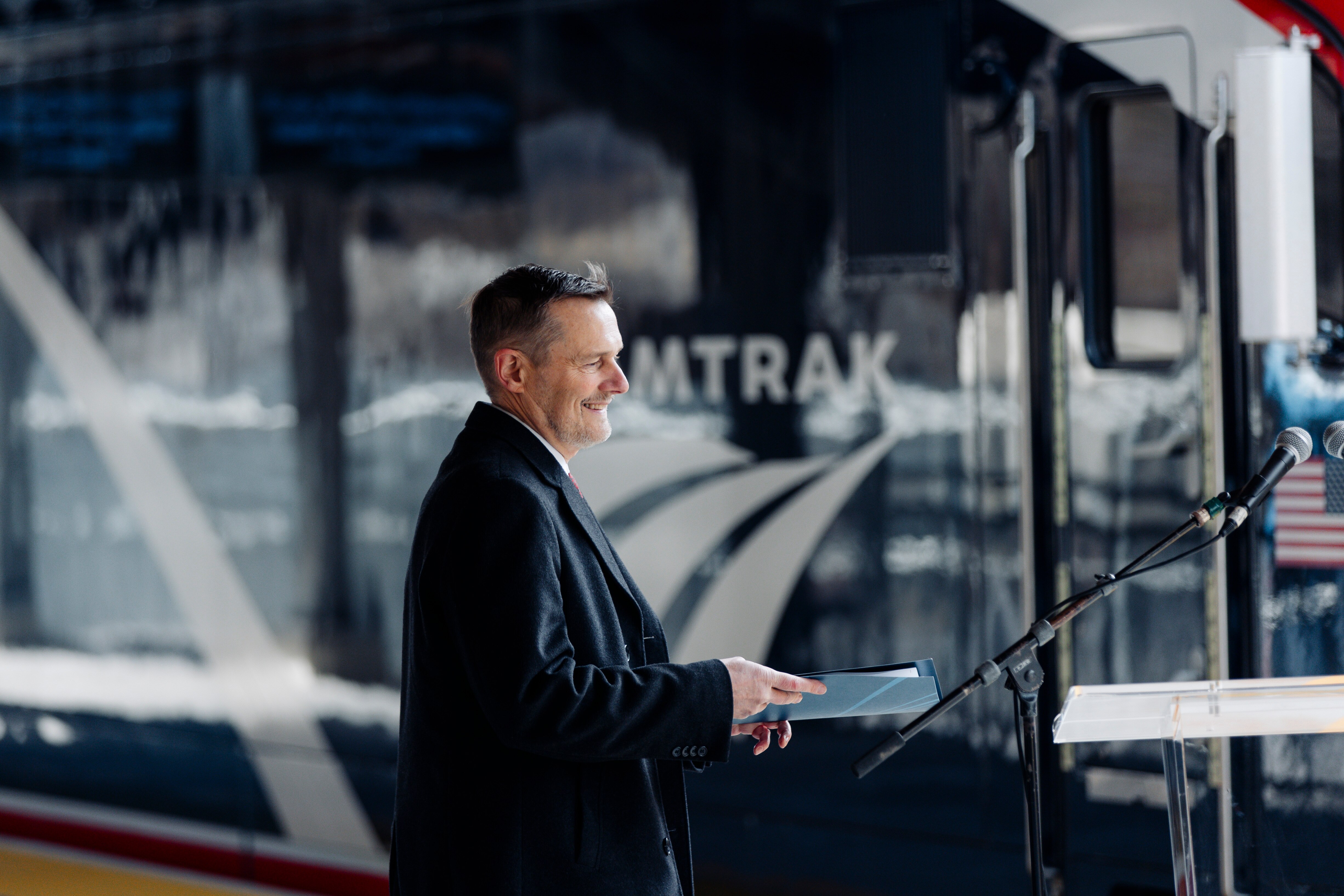 Amtrak President Roger Harris approaches the lectern at the opening of a newly constructed train platform at Baltimore’s Penn Station on Monday, Jan. 29, 2024.