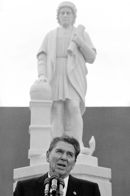 FILE - In this Monday, Oct. 9, 1984, file photo, President Ronald Reagan addresses a ceremony in Baltimore, to unveil a statue of Christopher Columbus. Baltimore’s mayor has vetoed a bill that would have rededicated a Christopher Columbus monument to victims of police violence. The Baltimore Sun says Democratic Mayor Bernard C. “Jack” Young shared concerns Monday, Nov. 16, 2020, with the city’s police commissioner that the two-story-tall obelisk is too close to a separate monument honoring fallen officers.