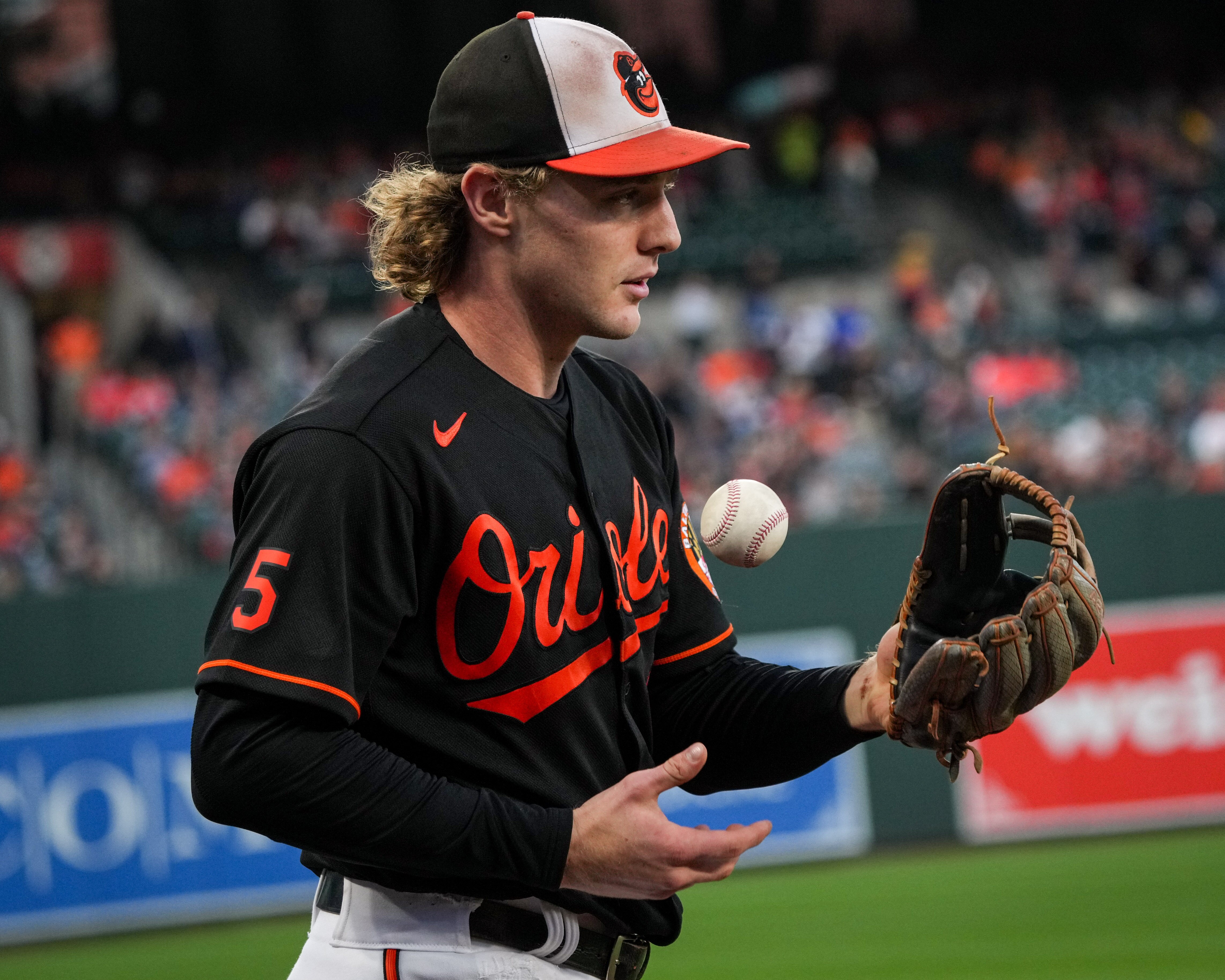 Baltimore Orioles third baseman Gunnar Henderson (2) tosses the ball to himself after making a catch near third base during the first inning of a baseball game against the Washington Nationals on Wednesday, Sept. 27, 2023.