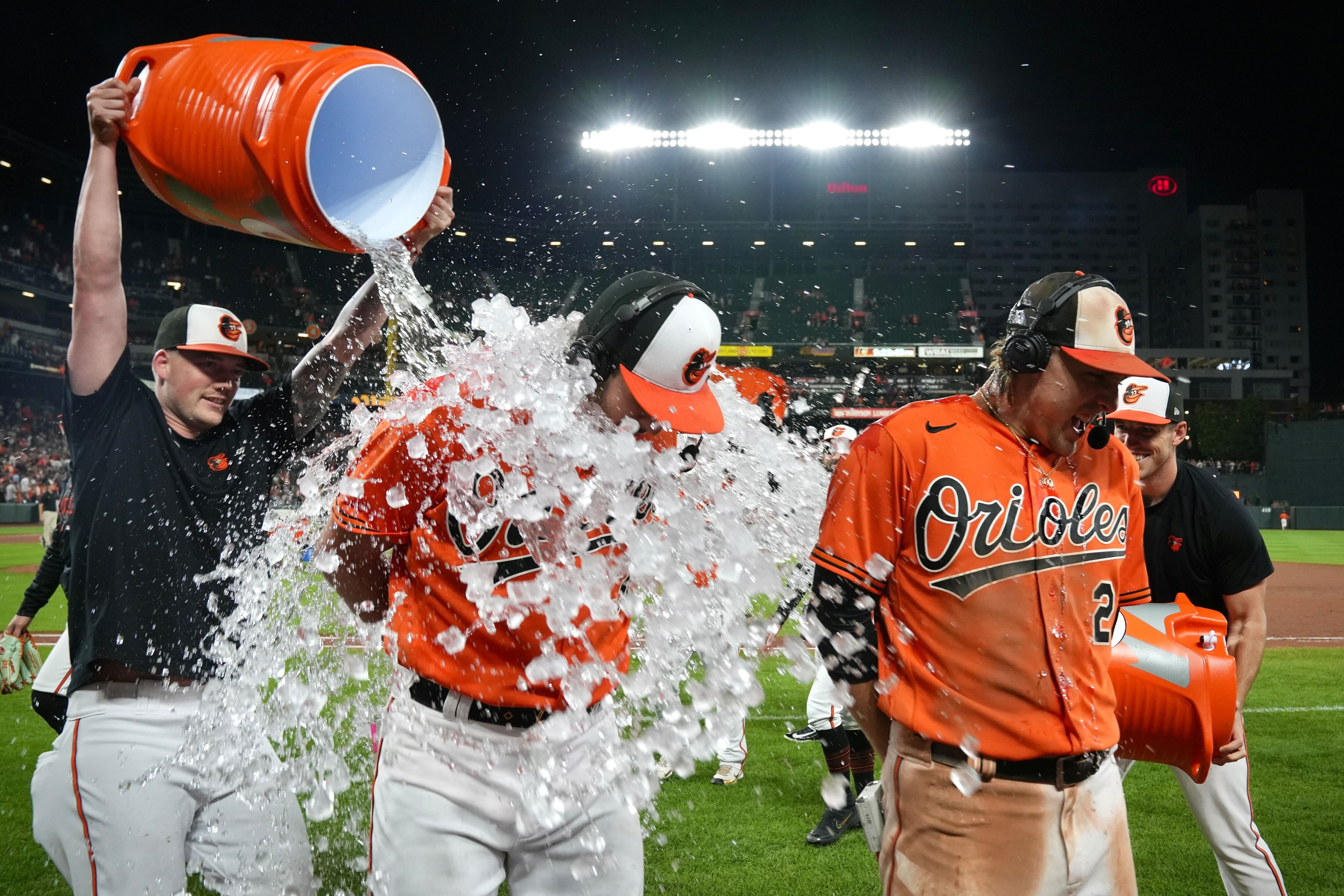 Baltimore Orioles starting pitcher Grayson Rodriguez and shortstop Gunnar Henderson get doused with water and gatorade by teammates after shutting out the Tampa Bay Rays 8-0 at Camden Yards Saturday night.
