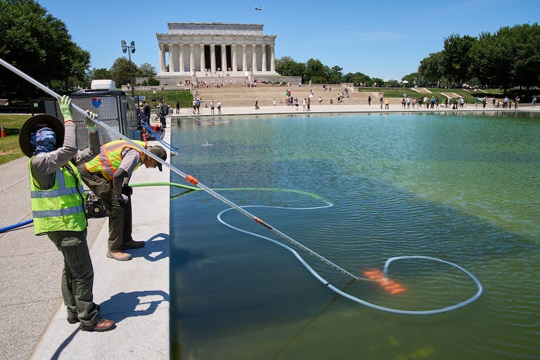 Members of the National Park Service clean algae from the Lincoln Memorial Reflecting Pool, Tuesday, June 16, 2026, in Washington.