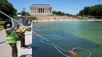 Members of the National Park Service clean algae from the Lincoln Memorial Reflecting Pool, Tuesday, June 16, 2026, in Washington.
