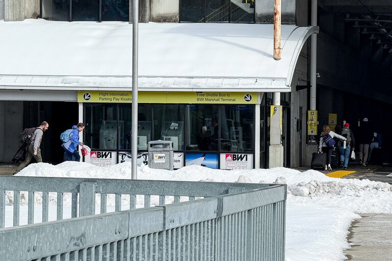 The Lubitz family runs to catch a shuttle bus at BWI on Monday.