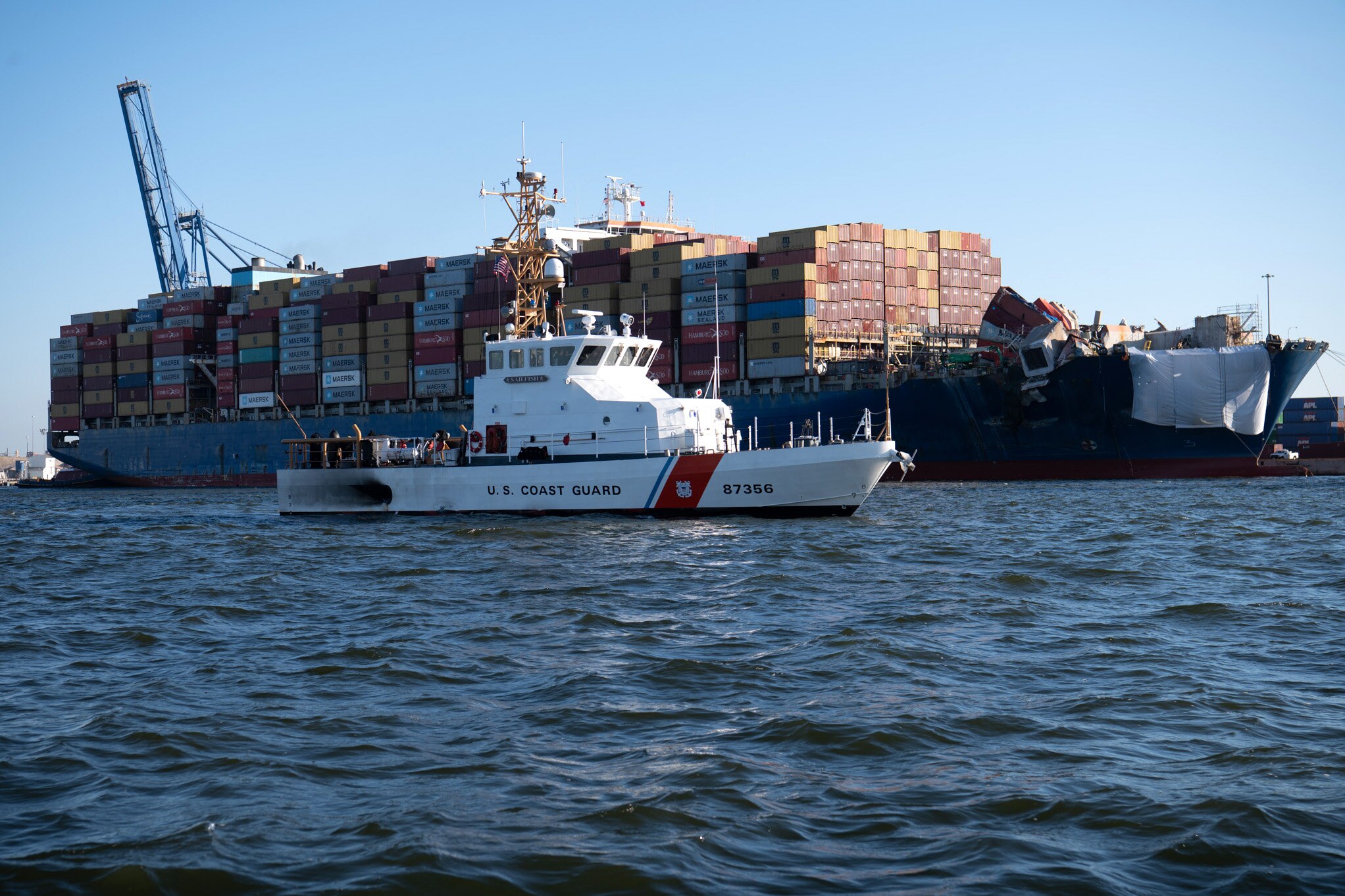 The crew of the U.S. Coast Guard Cutter Sailfish, an 87-foot Marine Protector-class vessel, prepares to escort the motor vessel Dali during its transit from the Port of Baltimore to the Port of Virginia, June 24, 2024. The Dali was scheduled to be accompanied to the Port of Virginia by four tug vessels while the U.S. Coast Guard Cutter Sailfish provided a security zone. (U.S. Coast Guard photo by Petty Officer 3rd Class Christopher Bokum)