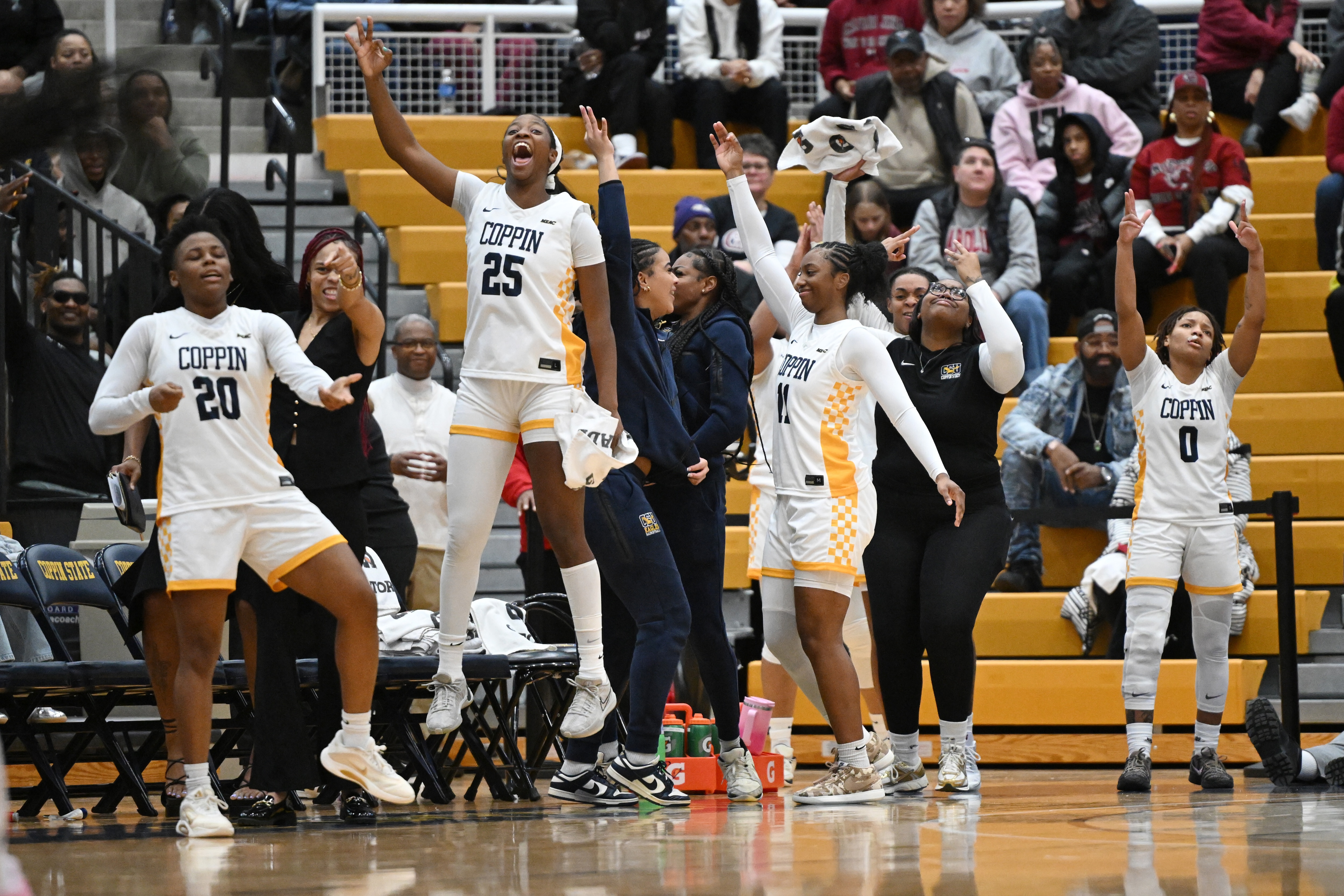 Members of the Coppin State team cheer during the second half of their home game against South Carolina on Sunday.