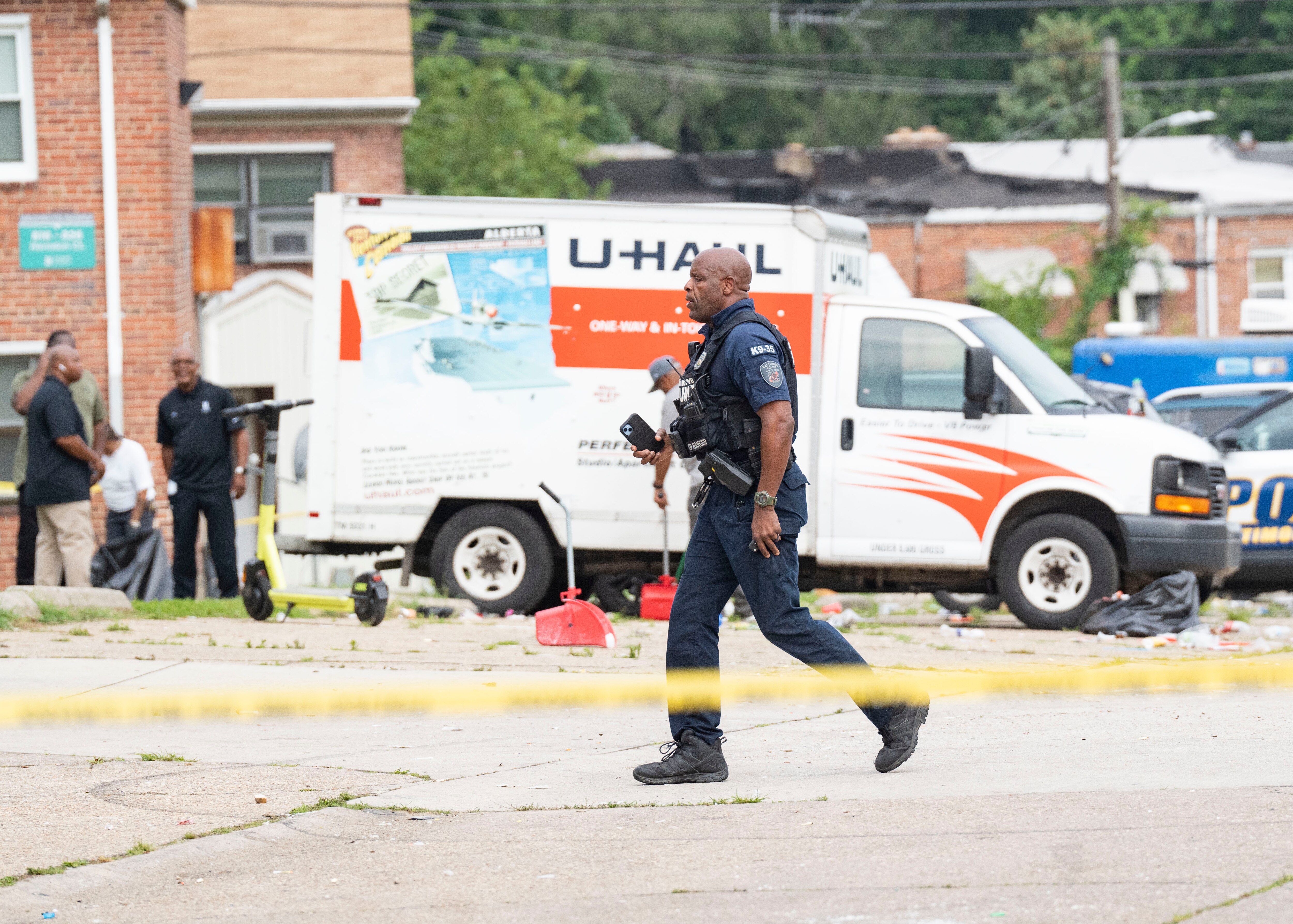 A police officer walks through the crime scene on Elarton Court in Brooklyn following a mass shooting on July 2.
