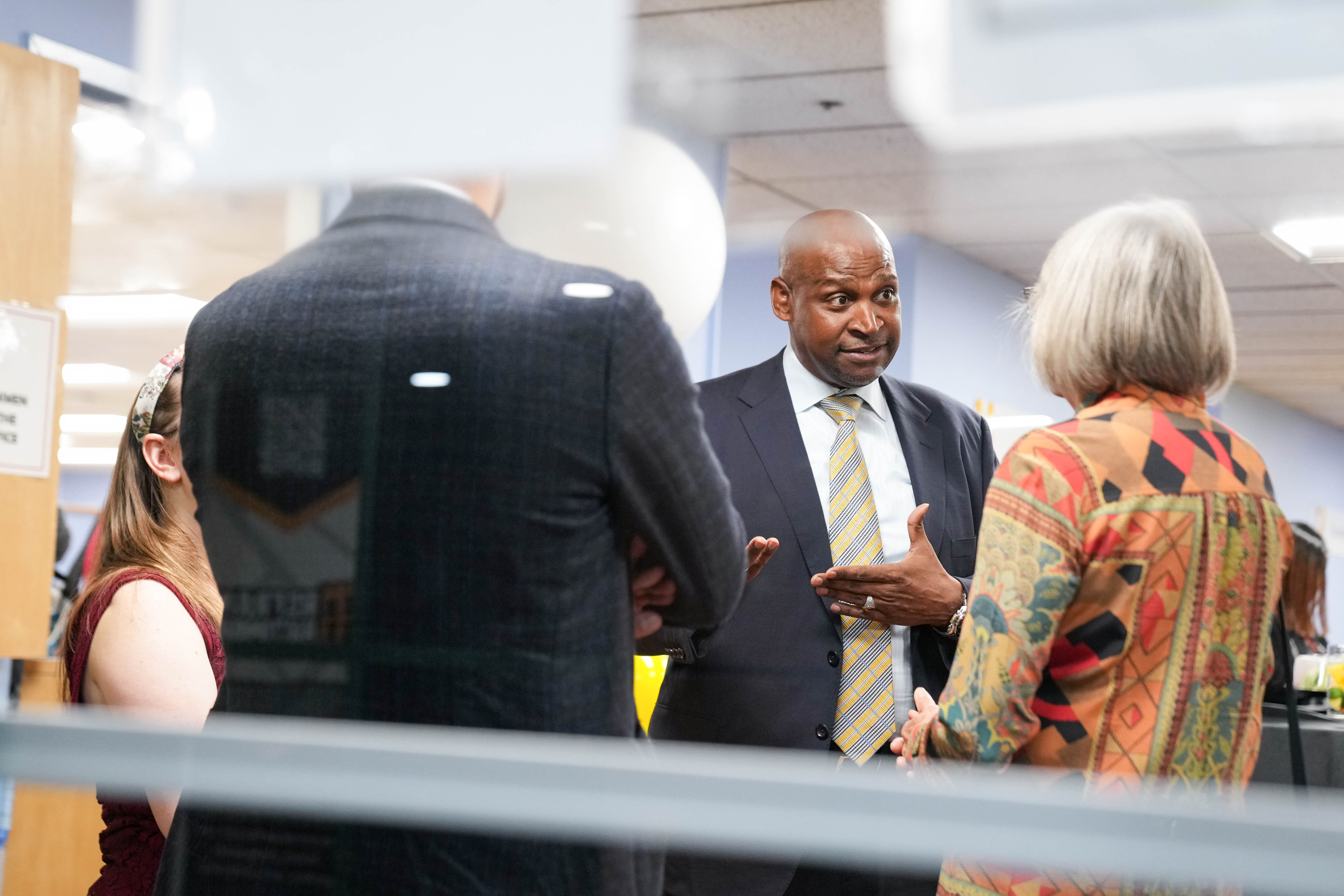 Incoming Election Director Clifford Tatum, center, speaks with guests during a reception at the Baltimore City Board of Elections on Thursday.