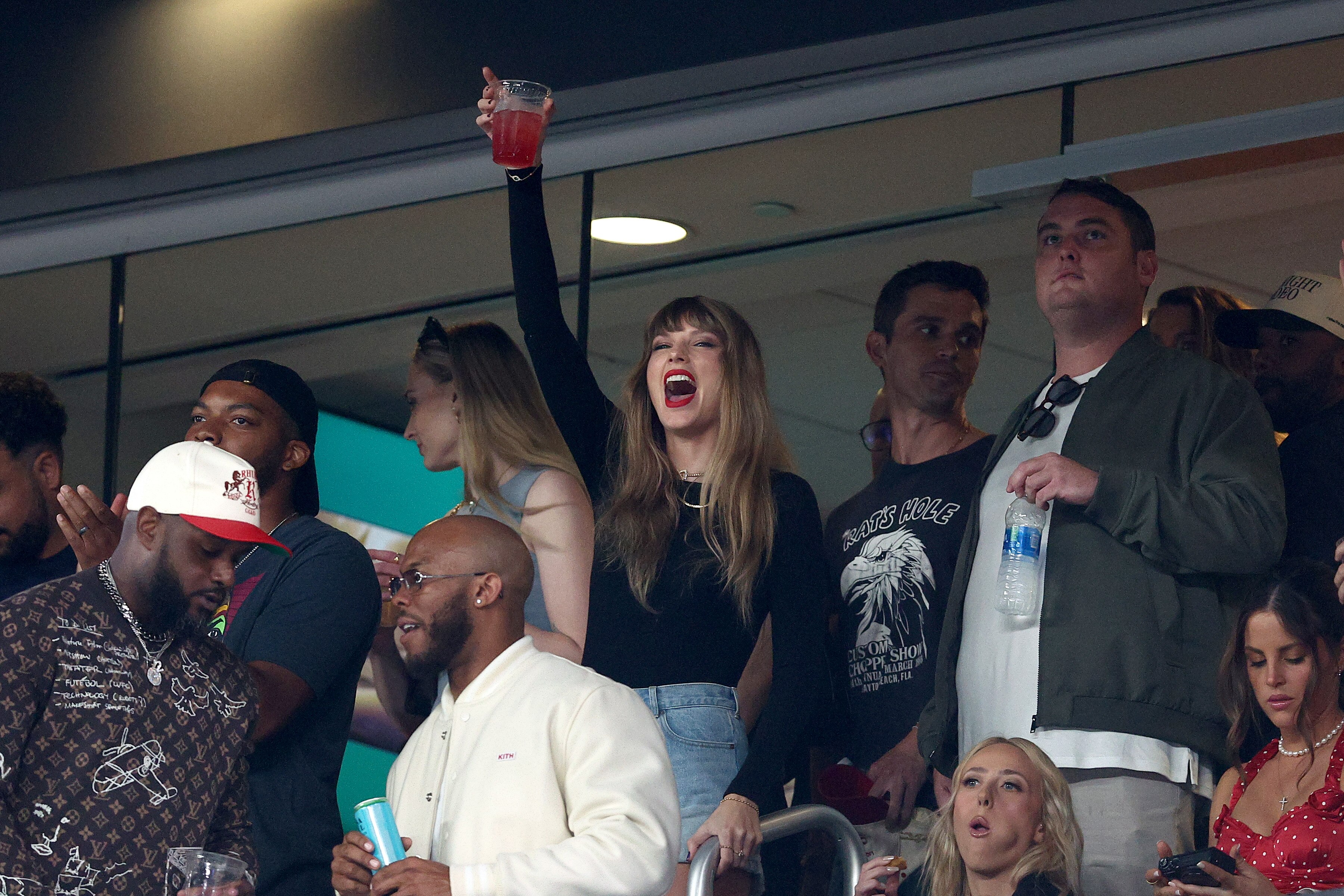Taylor Swift, center, flanked by actress Sophie Turner, left, and Antoni Porowski of “Queer Eye,” attends the Oct. 1 Kansas City Chiefs game. Actors Ryan Reynolds, Blake Lively and Hugh Jackman were also seated with her.