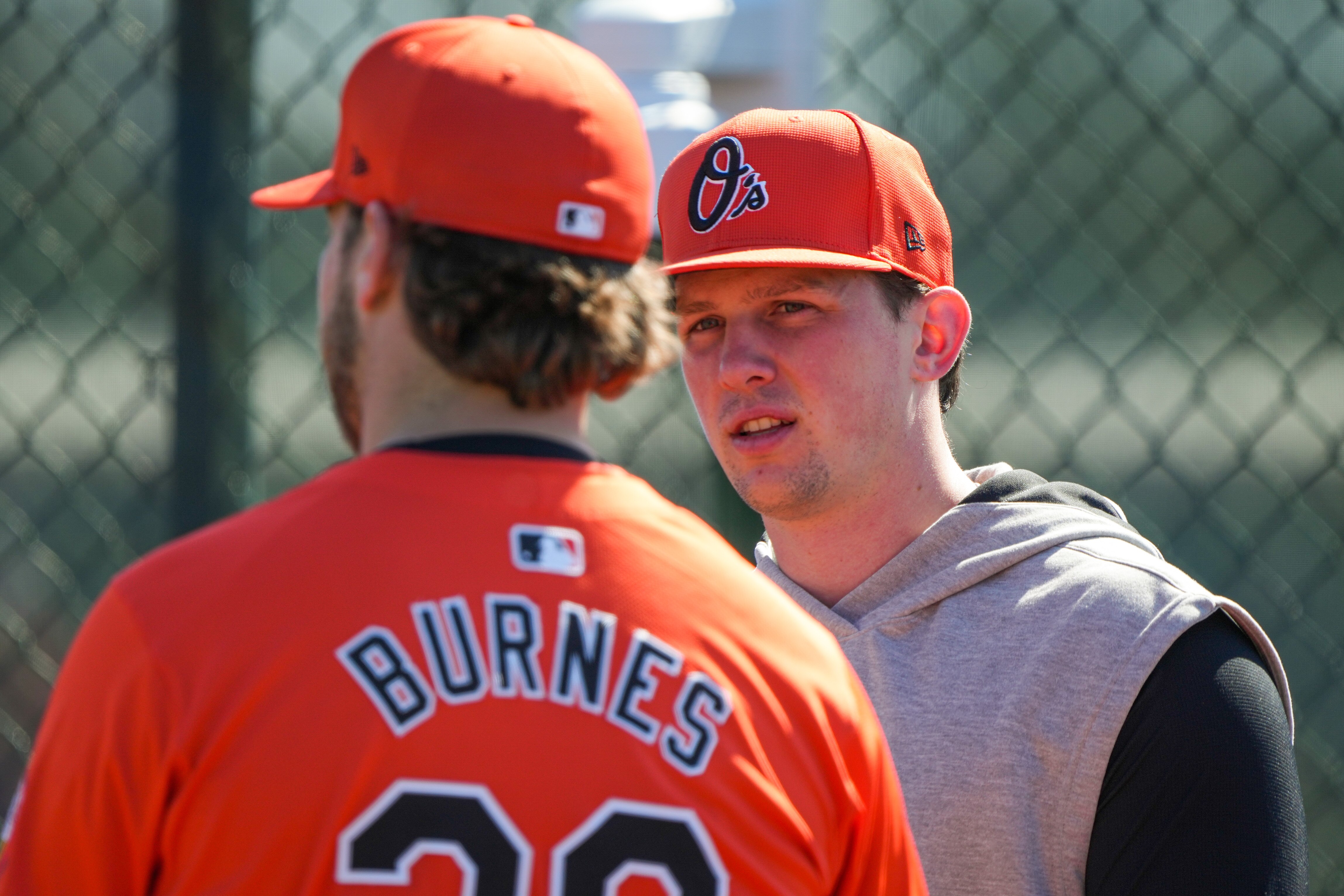 Orioles catcher Adley Rutschman, right, talks with starting pitcher Corbin Burnes at spring training Tuesday.